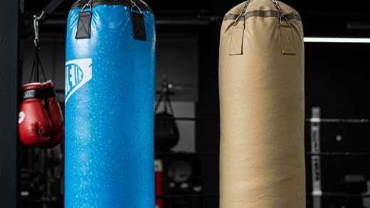 Boxer training with water and sand punching bags – Sting Sports