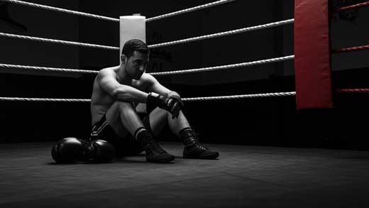 A boxer training on a heavy bag to improve focus and reduce stress.