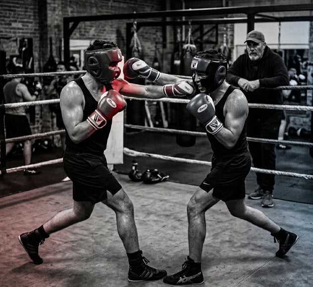 boxing sparring for beginners with two amateur boxers practicing controlled sparring in protective gear